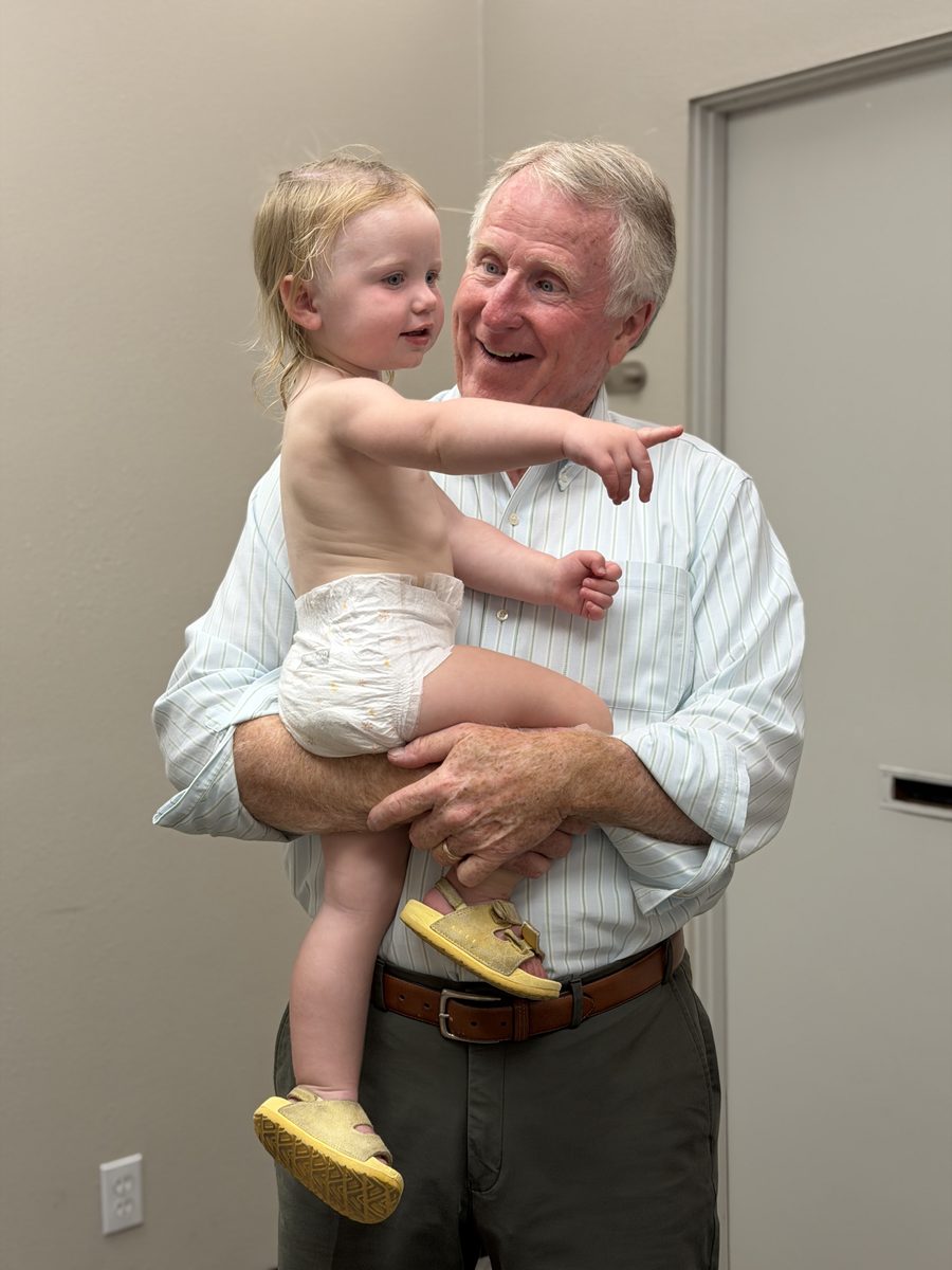 Dr. Monahan holding his grandchild at the office